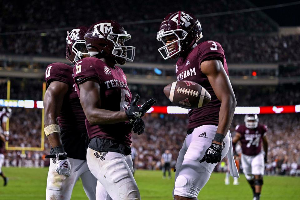 Texas A&M running back Devon Achane (6) and wide receiver Devin Price (3) celebrates a touchdown against Miami (Fla.) during the second half at Kyle Field.