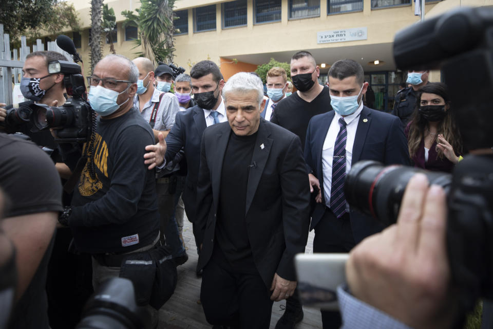Yesh Atid party leader Yair Lapid leaves after he voted for Israel's parliamentary election at a polling station in Tel Aviv, Israel, Tuesday, March. 23, 2021. Israel is holding its fourth election in less than two years. (AP Photo/Sebastian Scheiner)