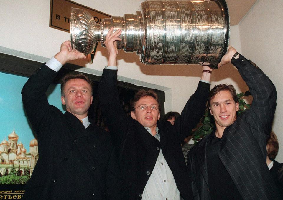 Red Wings champions Slava Fetisov, left, Igor Larionov, center, and Vyacheslav Kozlov hoist the Stanley Cup after its arrival to Russia, Saturday, Aug. 16, 1997. The three helped the Red Wings to the NHL championship in June. It is the first time that the Stanley Cup is in Russia.