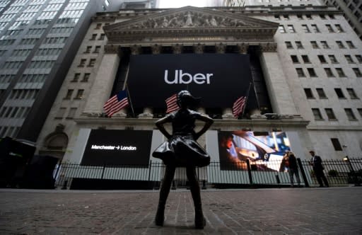 The "Fearless Girl" statue, by sculptor Kristen Visbal, stands outside the New York Stock Exchange (NYSE) ahead of the market debut for ride-hailing firm Uber