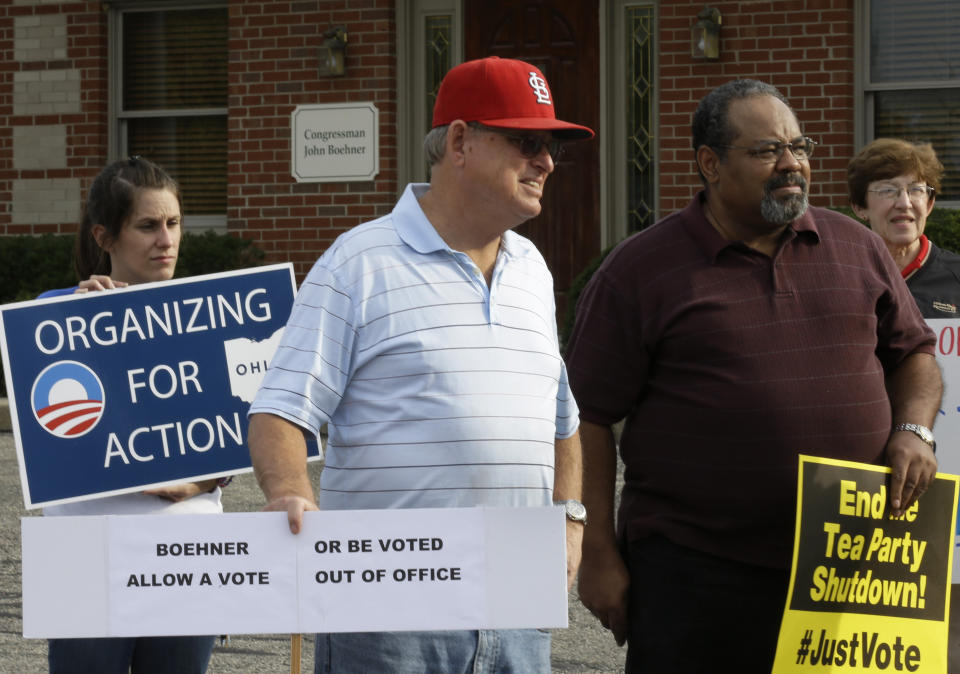 Protesters demonstrate outside the offices of Speaker John Boehner (R-Ohio), Tuesday, Oct. 15, 2013, in West Chester, Ohio. The government shutdown is entering its third week. (AP Photo/Al Behrman)
