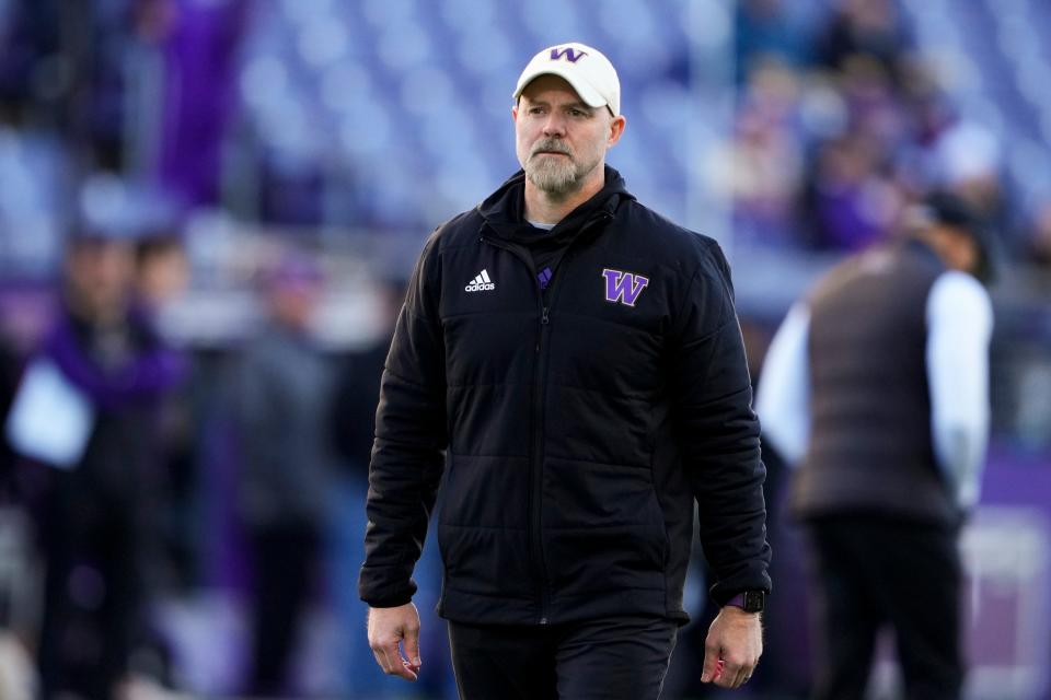 Washington offensive coordinator Ryan Grubb walks on the field before an NCAA college football game against Washington State, Nov. 25, 2023, in Seattle. Kalen DeBoer has made a rapid rise through the coaching ranks. He won three NAIA national championships as head coach at the University of Sioux Falls from 2005-09 and had five coaching stops in 12 years before landing at Washington. His offensive coordinator, Grubb, and defensive coordinator, Chuck Morrell, were on his staff at Sioux Falls.