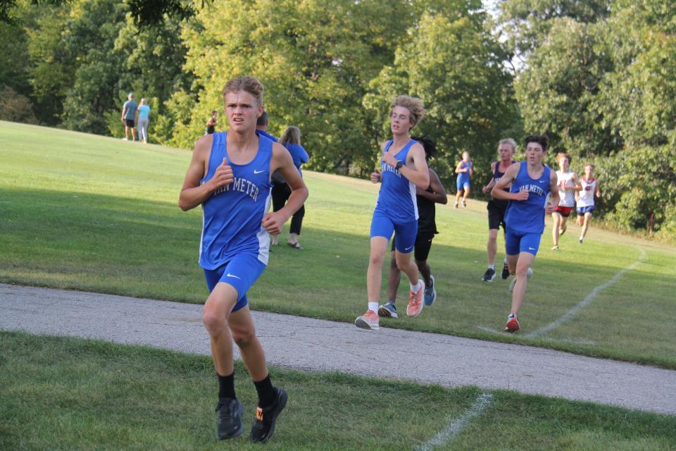 From left, Van Meter's Kaegan Wigant, Liam Newell and Hayden Lindsey run during the Tiger Invitational on Monday, Sept. 18, 2023, at Hillcrest Country Club in Adel.