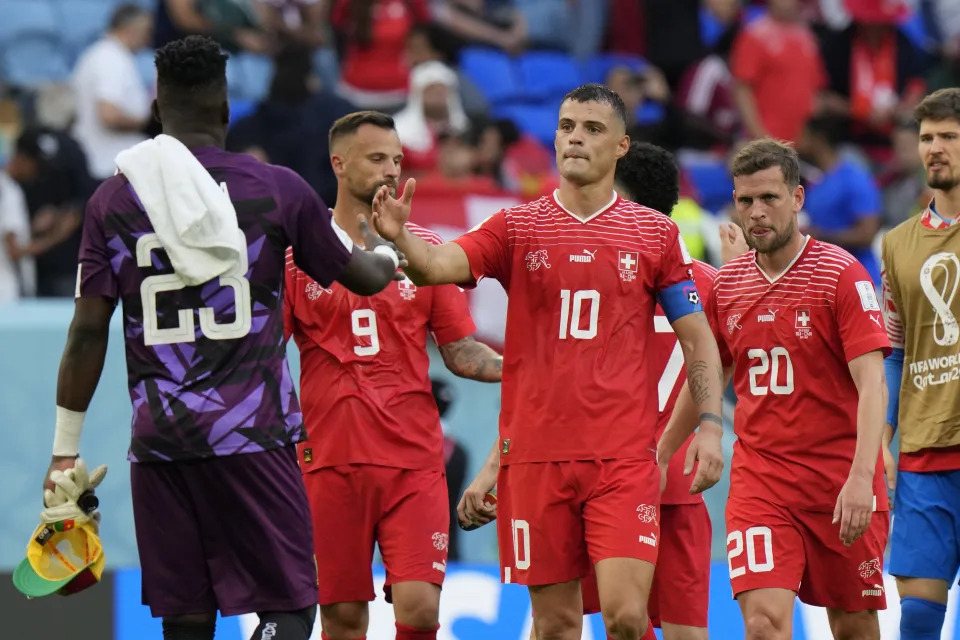 Switzerland's Granit Xhaka greets Cameroon's goalkeeper Andre Onana at the end of the World Cup group G soccer match between Switzerland and Cameroon, at the Al Janoub Stadium in Al Wakrah, Qatar, Thursday, Nov. 24, 2022. Switzerland won 1-0. (AP Photo/Luca Bruno)