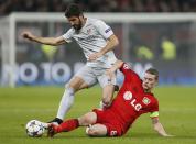 Bayer Leverkusen's Lars Bender challenges Atletico Madrid's Raul Garcia (L) during their Champions League round of 16, first leg soccer match in Leverkusen February 25, 2015. REUTERS/Wolfgang Rattay (GERMANY - Tags: SPORT SOCCER TPX IMAGES OF THE DAY)