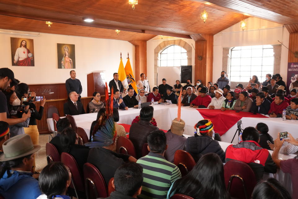 Government representatives and the Indigenous organization leading the ongoing protests meet to find possible solutions that could lead to the end of a strike that has paralyzed parts of the country for the last two weeks, at the Basilica del Voto Nacional in Quito, Ecuador, Tuesday, June 28, 2022. (AP Photo/Dolores Ochoa)