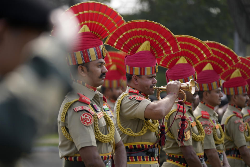 Indian Border Security Force (BSF) soldiers pay tribute to their colleague Lal Fam Kima during a wreath-laying ceremony at the BSF headquarters in Jammu, India, Thursday, Nov.9, 2023. The BSF soldier was killed as Indian and Pakistani soldiers exchanged gunfire and shelling along their highly militarized frontier in disputed Kashmir. (AP Photo/Channi Anand)