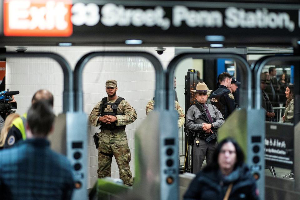 National Guard troops and New York State Police officers patrol Penn Station in New York City on 7 March. (REUTERS)