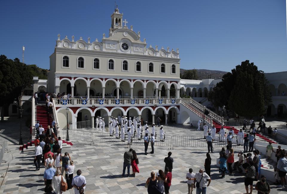 Pilgrims stand in a queue as they wait to enter the Holy Church of Panagia of Tinos, on the Aegean island of Tinos, Greece, on Saturday, Aug. 15, 2020. For nearly 200 years, Greek Orthodox faithful have flocked to Tinos for the August 15 feast day of the Assumption of the Virgin Mary, the most revered religious holiday in the Orthodox calendar after Easter. But this year there was no procession, the ceremony _ like so many lives across the globe _ upended by the coronavirus pandemic. (AP Photo/Thanassis Stavrakis)