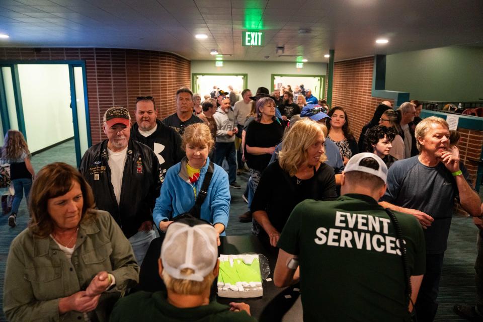 Community members flood through the doors to get a chance to see the newly renovated Val Air Ballroom during the venue's ribbon-cutting ceremony Sunday.