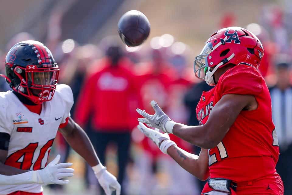 Carl Albert’s Xavier Robinson (21) catches a pass for a touchdown and is brought down in the end zone by Del City’s Ricklan Holmes (40) during the 5A high school football state championship game between Carl Albert and Del City at Chad Richison Stadium in Edmond, Okla., on Saturday, Dec. 2, 2023.