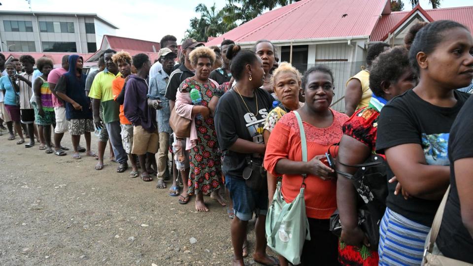Voters queue to vote in Honiara during the Solomon Islands election