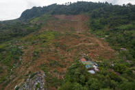 A bird's eye view of the Honduran hilltop community La Reina, seven months after it was buried by a mudslide triggered by the November 2020 Hurricanes Eta and Iota, Tuesday, June 29, 2021. To rebuild their houses and replant their crops, the villagers needed land -- much of which is in the hands of drug traffickers. (AP Photo/Rodrigo Abd)