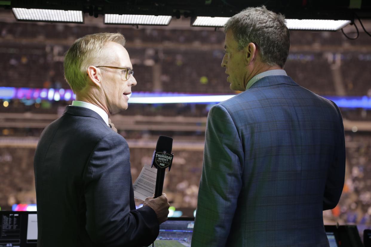 Troy Aikman, right, and Joe Buck in the booth before an NFL game.