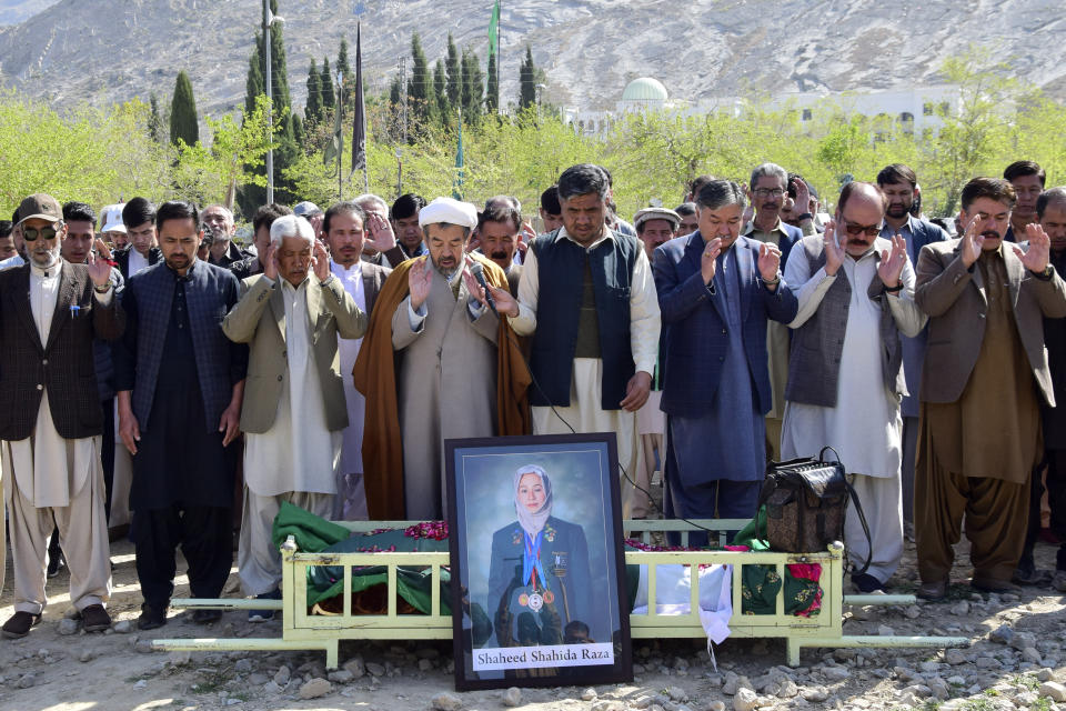 Relatives and mourners attend funeral prayer of female field hockey player Shahida Raza, who died in the shipwreck tragedy, in Quetta, Pakistan, Friday, March 17, 2023. Raza was among other migrants who died in a shipwreck off Italy's southern coast. The migrants' wooden boat, crammed with passengers who paid smugglers for the voyage from Turkey, broke apart in rough water just off a beach in Calabria. (AP Photo/Arshad Butt)