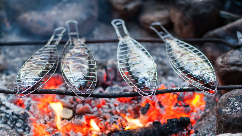Fish grilling over flame