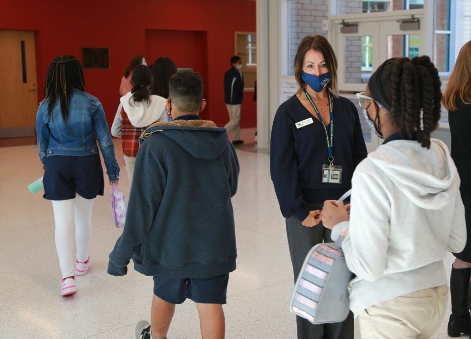 Principal Tara Fitzgerald talks to middle schoolers as they pass on their way to the cafeteria.