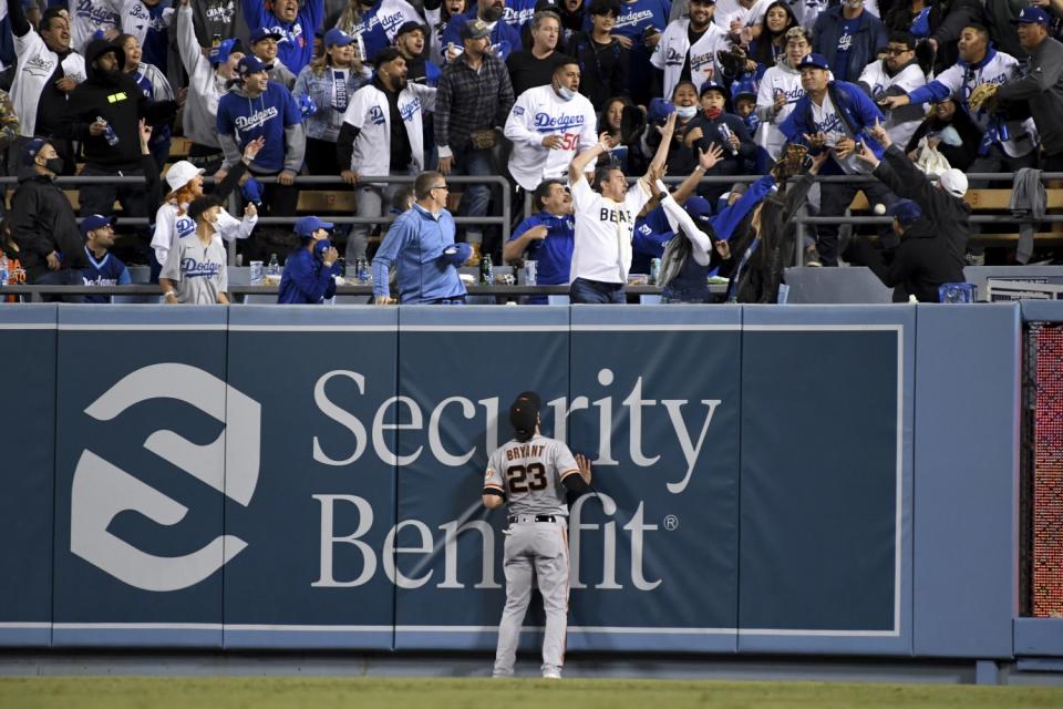 Giants right fielder Kris Bryant looks up as fans try to catch a two-run home run by Dodgers' Mookie Betts