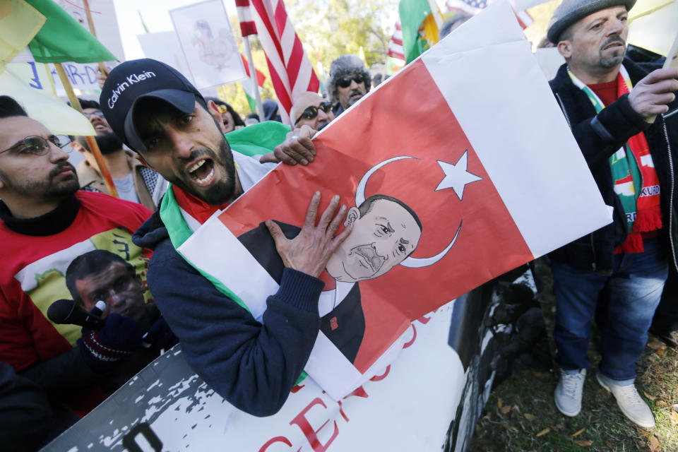 Protesters rally against the Washington visit of Turkish President Recep Tayyip Erdogan outside the White House, Wednesday, Nov. 13, 2019, in Washington. (AP Photo/Steve Helber)