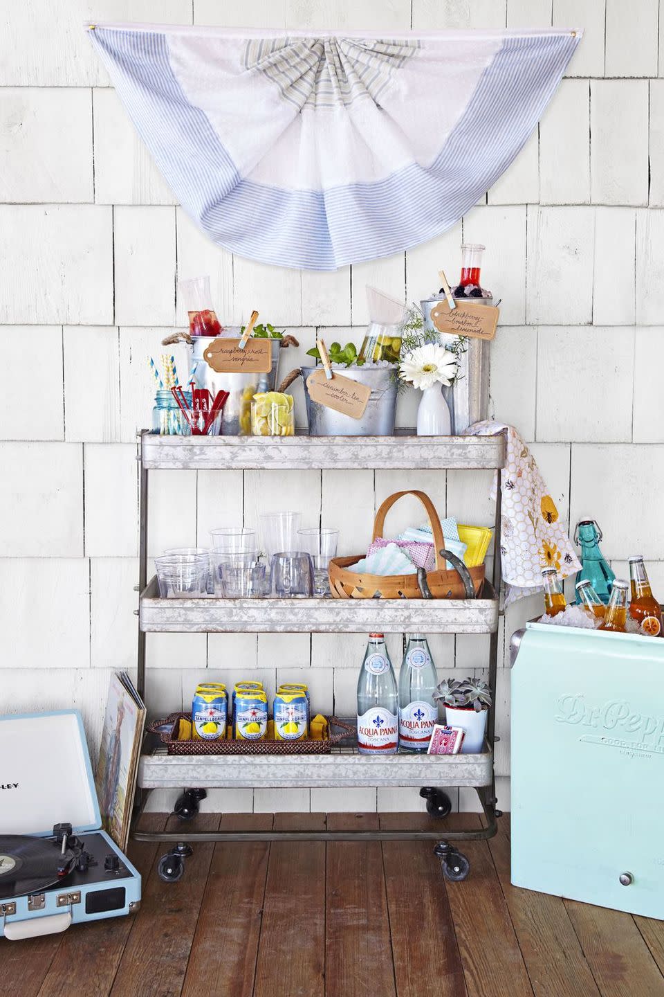 <p>Designate a spot for drinks to ensure that everyone stays calm, cool and hydrated on hot summer days. Pick a cart with wheels, so you can roll it inside to keep the drinks pouring. </p><p><strong>RELATED:</strong> <a href="https://www.goodhousekeeping.com/home/g31206630/outdoor-bar-ideas/" rel="nofollow noopener" target="_blank" data-ylk="slk:The Best Outdoor Bar Cart Ideas;elm:context_link;itc:0;sec:content-canvas" class="link ">The Best Outdoor Bar Cart Ideas </a></p>