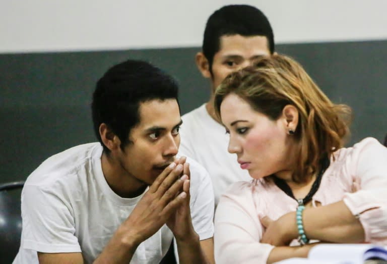 Pastor Juan Rocha (L) talks to his lawyer during an initial hearing in Managua into charges he killed a mother of two he claimed was "possessed by a demon"