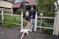 Australia's Prime Minister-elect Anthony Albanese, right, and his partner Jodie Haydon go for a walk with their dog, Toto, in Sydney, Sunday, May 22, 2022. Albanese has promised to rehabilitate Australia's international reputation as a climate change laggard with steeper cuts to greenhouse gas emissions. (Dean Lewins/AAP Image via AP)