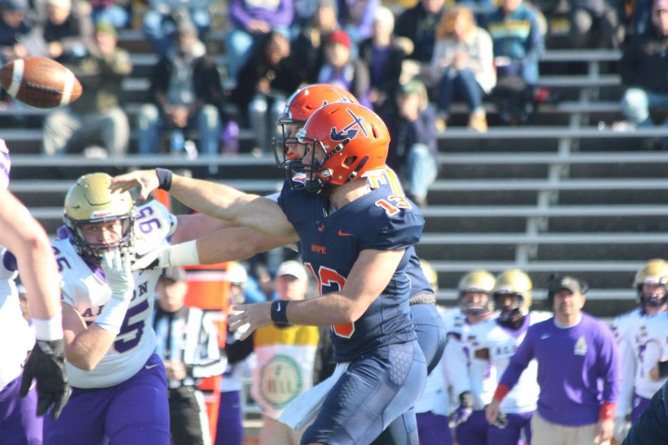 Hope QB Chase Brown makes a throw under pressure against Albion in 2021