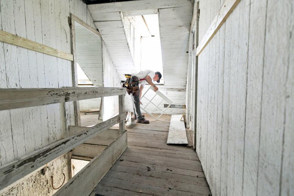 artis construction’s parker stuartz installs a replica window