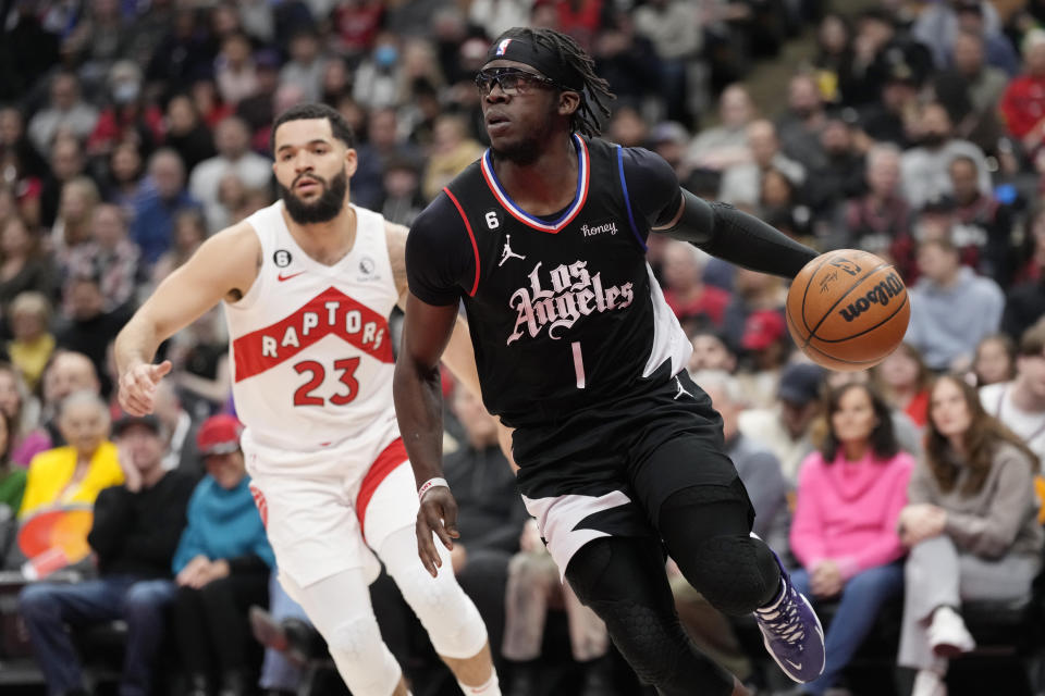 Los Angeles Clippers guard Reggie Jackson (1) drives past Toronto Raptors guard Fred VanVleet (23) during the first half of an NBA basketball game Tuesday, Dec. 27, 2022, in Toronto. (Frank Gunn/The Canadian Press via AP)