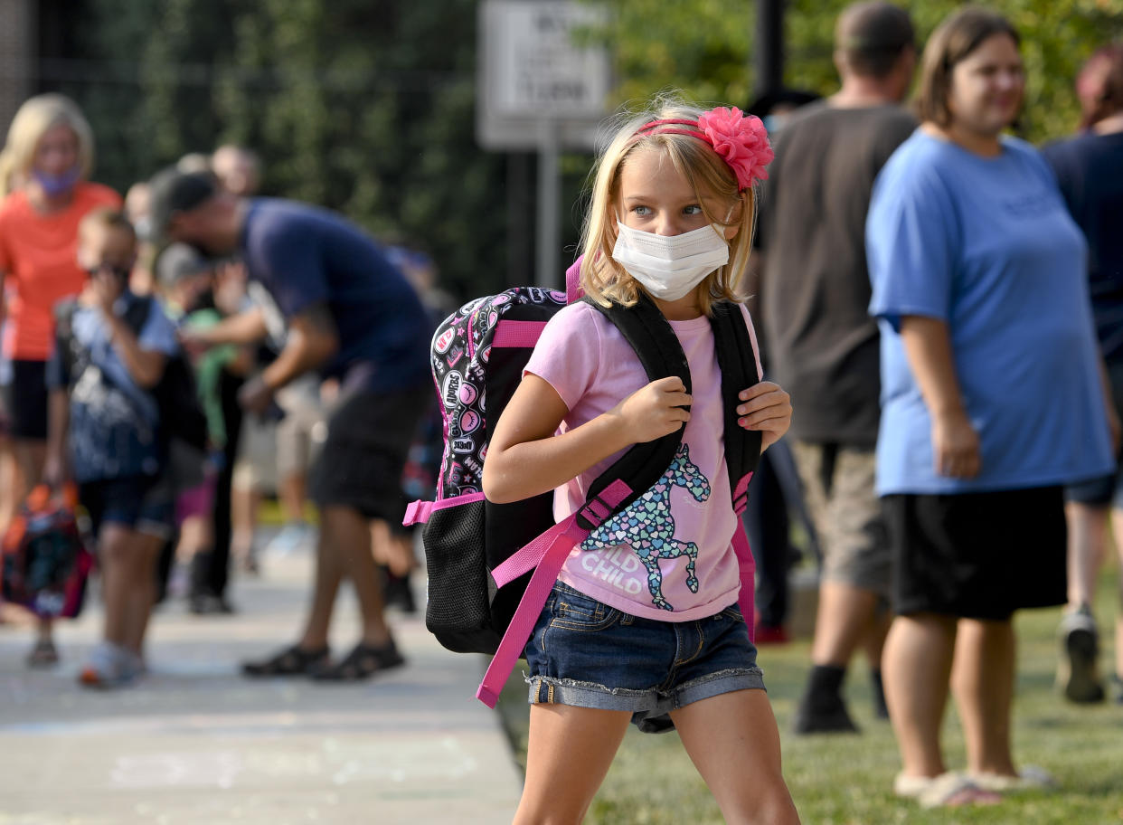 A new study suggests that kids with coronavirus may be asymptomatic, and could carry the virus for more than two weeks. Picture above, a first grade student heading back to school on August 27 in Pennsylvania. (Photo: Getty Images). 