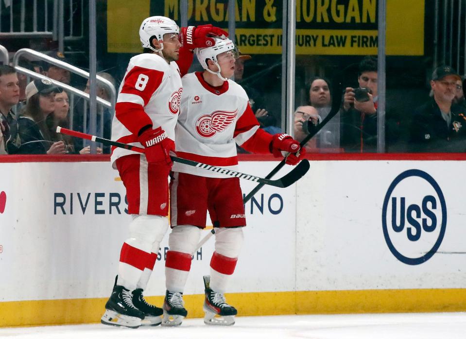 Red Wings defenseman Ben Chiarot, left, congratulates left wing Lucas Raymond on his goal against the Penguins during the first period on Thursday, April 11, 2024, in Pittsburgh.