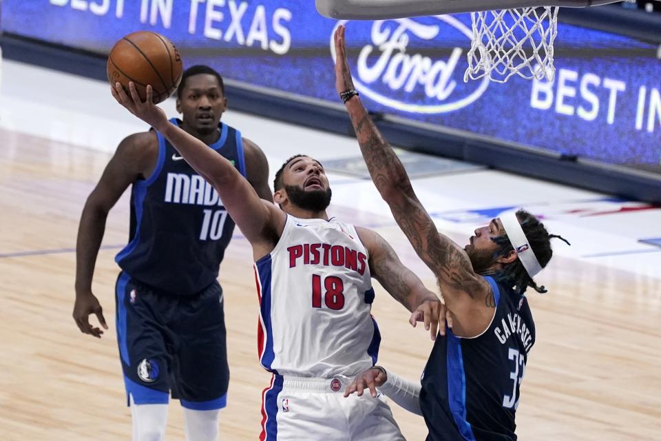 Detroit Pistons guard Cory Joseph (18) shoots as Dallas Mavericks' Dorian Finney-Smith (10) and Willie Cauley-Stein defend during the second half of an NBA basketball game in Dallas, Wednesday, April 21, 2021. (AP Photo/Tony Gutierrez)