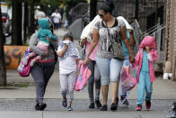 <p>Two woman accompany children to the Cayuga Centers in New York, Thursday, June 21, 2018. New York City Mayor Bill de Blasio says he learned on Wednesday that hundreds of migrant children separated from their parents by federal immigration officials are being cared for in the facility. (Photo: Richard Drew/AP) </p>