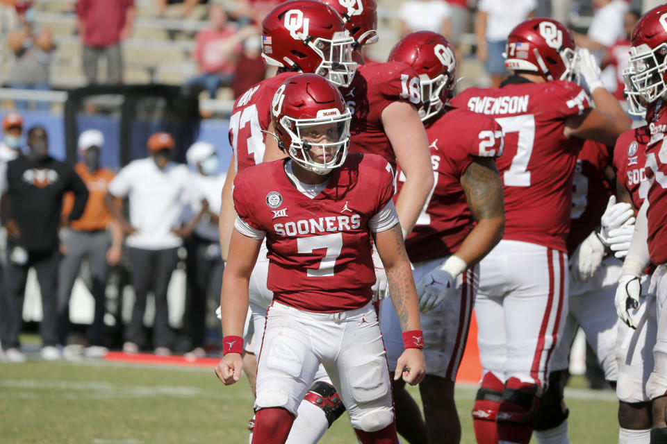 Oklahoma quarterback Spencer Rattler (7) reacts after scoring a touchdown in overtime against Texas during an NCAA college football game in Dallas, Saturday, Oct. 10, 2020. Oklahoma defeated Texas 53-45 in four overtimes. (AP Photo/Michael Ainsworth)