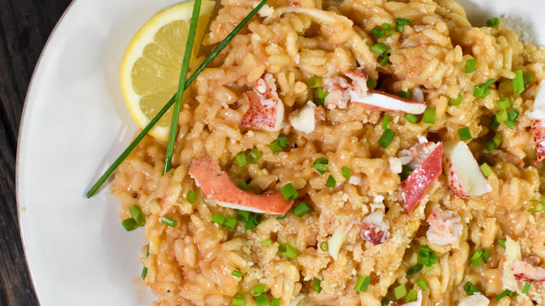 Lobster risotto with lemon wedge