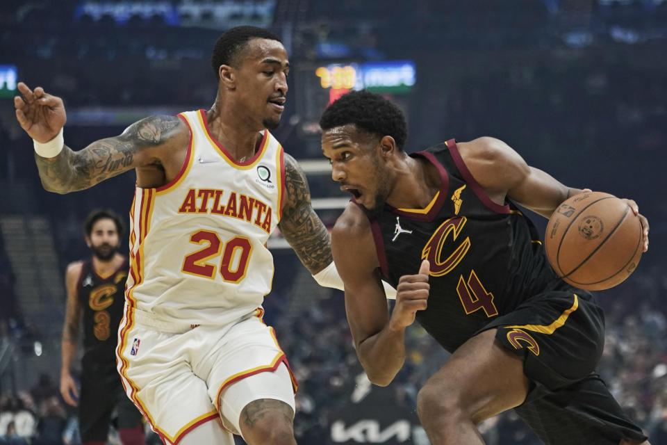 Cleveland Cavaliers' Evan Mobley (4) drives against Atlanta Hawks' John Collins (20) in the first half of an NBA basketball game, Saturday, Oct. 23, 2021, in Cleveland. (AP Photo/Tony Dejak)