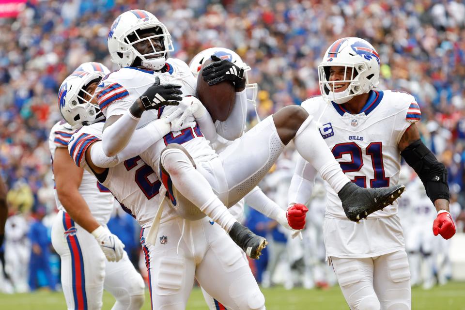 Buffalo Bills cornerback Tre'Davious White (27) celebrates with Bills safety Micah Hyde (23) after intercepting a pass in the end zone against the Washington Commanders during the third quarter.