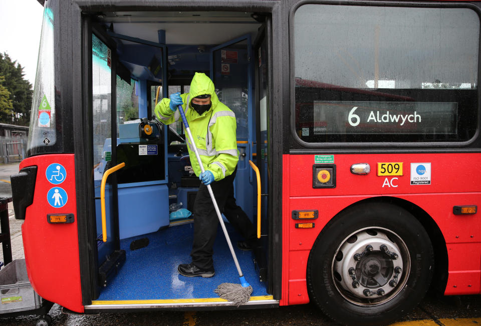 A Metroline worker cleans a bus at Willesden Bus Garage in north west London, as the UK continues in lockdown to help curb the spread of the coronavirus. Picture date: Tuesday April 28, 2020.
