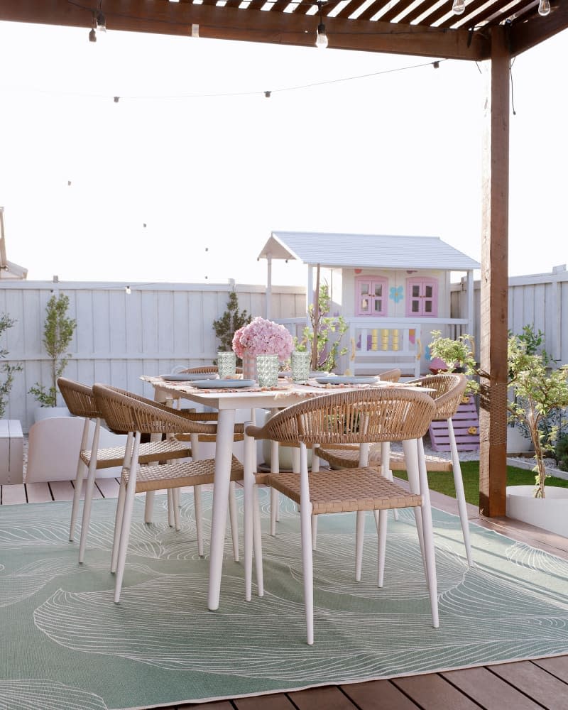 yard with dining area and kids playhouse