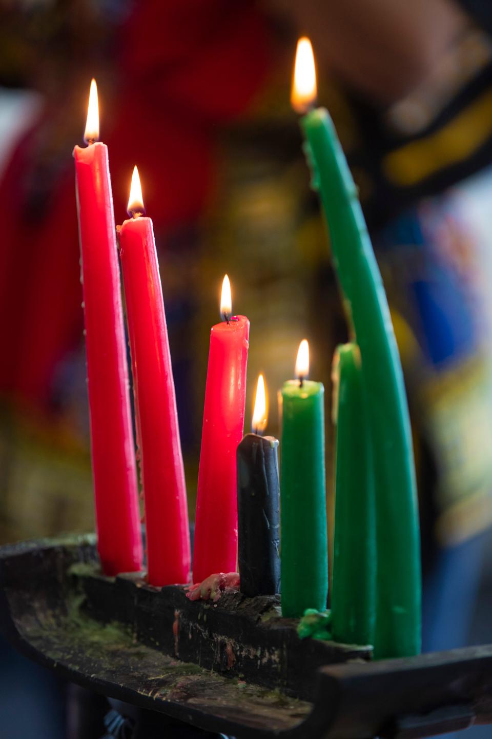 Kwanzaa candles are lit Friday inside the Liberated Minds Homeschool Academy education space at Launch Louisville. Dec. 11, 2020