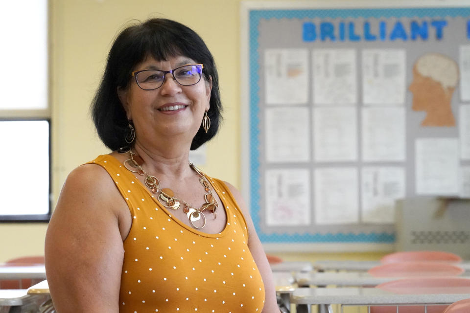 Geraldine Swann, director of community outreach at Hampstead Hill Academy in Baltimore, poses for a photograph Monday, Aug. 31, 2020, in Baltimore. The pandemic has Geri Swann working her cell phone constantly, as she gets up to 100 emails a day seeking help for students and their families. Finding them Chromebooks, buying eyeglasses for kids squinting at screens. Helping people get unemployment checks. Delivering groceries so a woman can feed her school-aged grandchildren while their parents recover from COVID-19. This is what a community schools coordinator does _ and as a new academic year begins in the throes of coronavirus infections, Swann has only been busier in support of the struggling families at her diverse Baltimore charter school.(AP Photo/Julio Cortez)