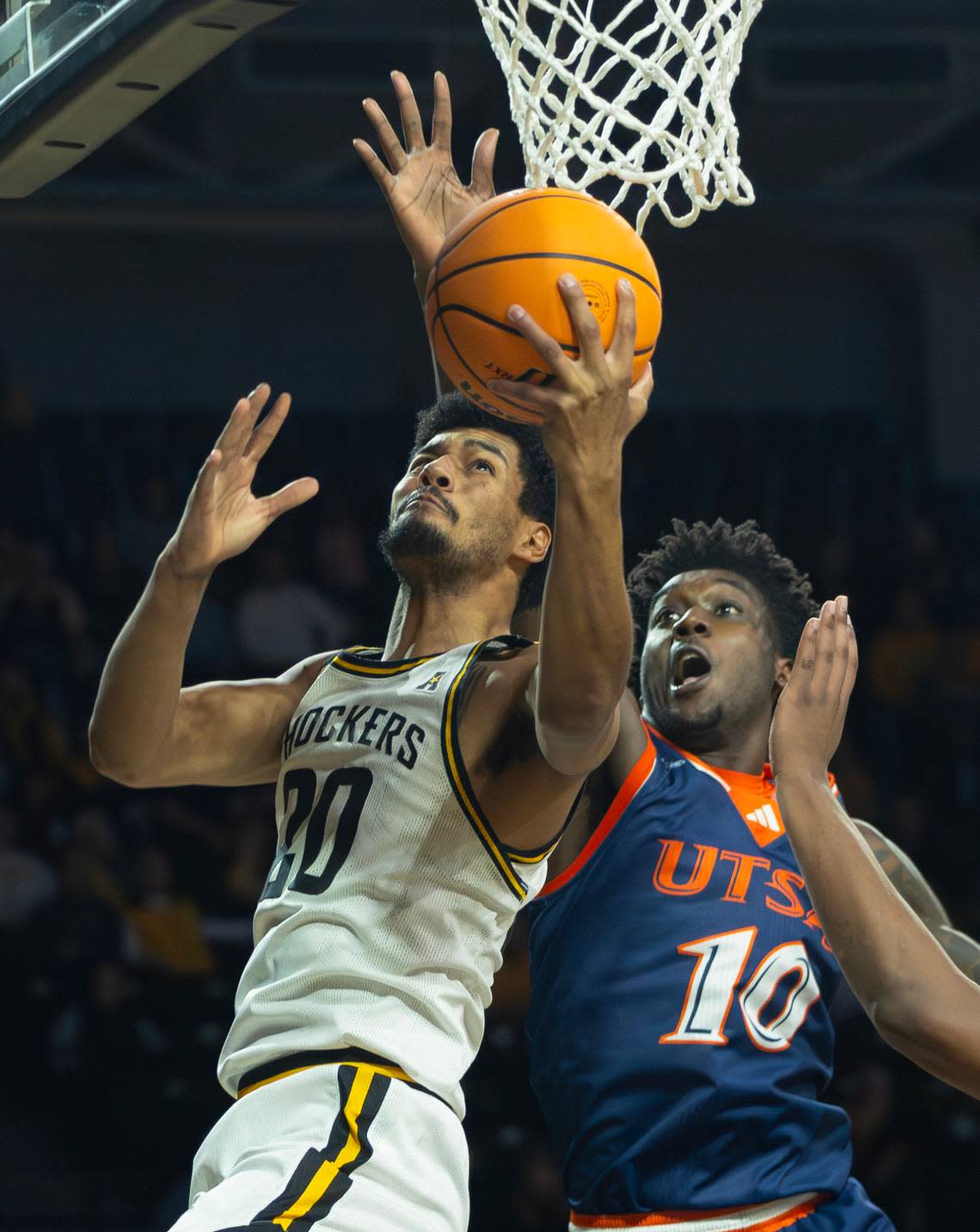 Wichita State’s Harond Beverly shoots a reverse layup against UTSA defender Chandler Cuthrell in the first half of Wednesday night’s game. Travis Heying/The Wichita Eagle