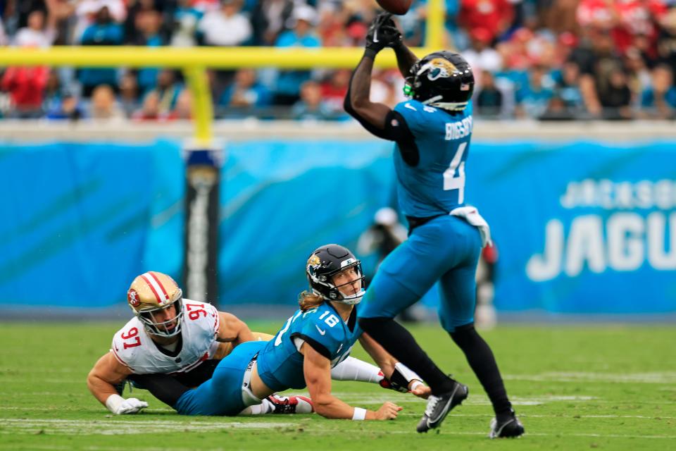 Jacksonville Jaguars quarterback Trevor Lawrence (16) watches his pass get tipped by running back Tank Bigsby (4) after being pressured by San Francisco 49ers defensive end Nick Bosa (97) during the third quarter of an NFL football game Sunday, Nov. 12, 2023 at EverBank Stadium in Jacksonville, Fla. The San Francisco 49ers defeated the Jacksonville Jaguars 34-3. [Corey Perrine/Florida Times-Union]