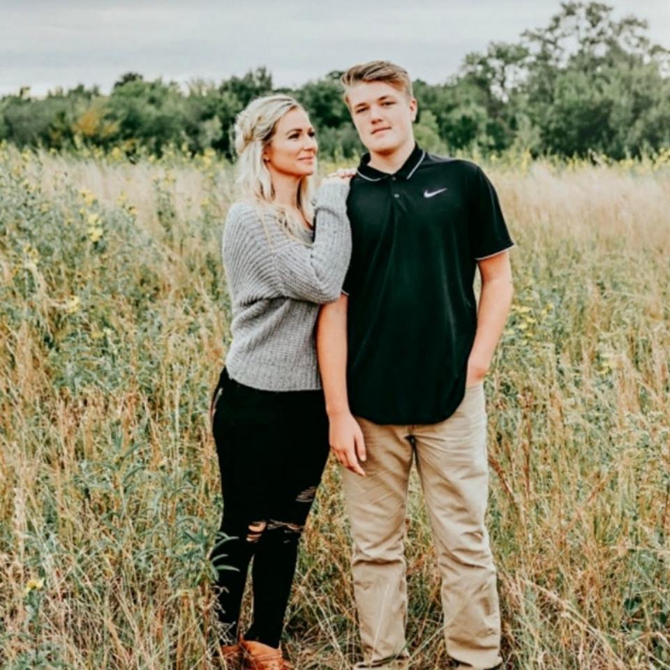 Jamie Hilburn stands in a field with her son in 2018.