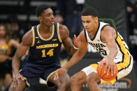 Iowa forward Keegan Murray (15) drives around Michigan forward Moussa Diabate (14) during the first half of an NCAA college basketball game, Thursday, Feb. 17, 2022, in Iowa City, Iowa. (AP Photo/Charlie Neibergall)