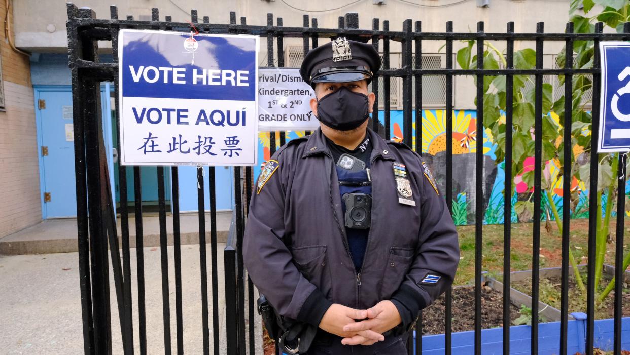 NYPD 81st Precinct Officer Orsini stands outside PS 81, the polling place of Democratic mayoral candidate Eric Adams, in the Bedford Stuyvesant section of Brooklyn on Tuesday, Nov. 2, 2021.