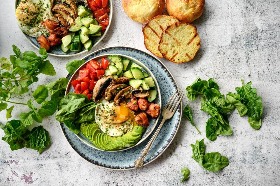 Two salads and some slices of bread.