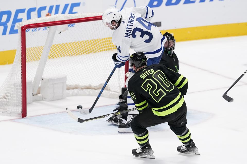 Dallas Stars defenseman Ryan Suter (20) watches as Toronto Maple Leafs center Auston Matthews (34) scores against goaltender Scott Wedgewood in overtime of an NHL hockey game Thursday, April 7, 2022, in Dallas. The Maple Leafs won 4-3. (AP Photo/Tony Gutierrez)