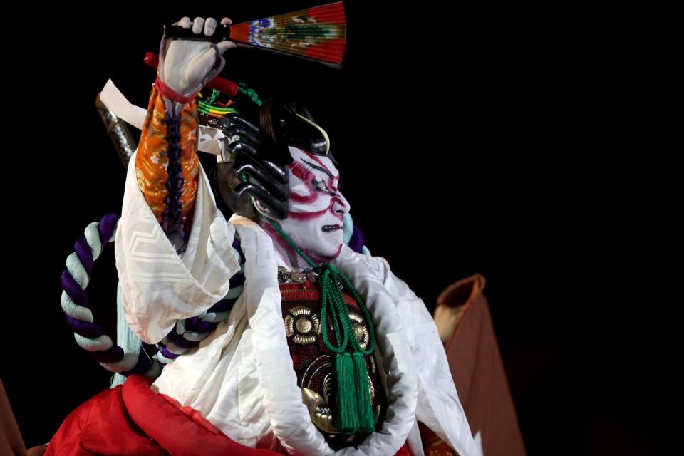 A performer dressed as a Samurai acts out a routine during the Opening Ceremony