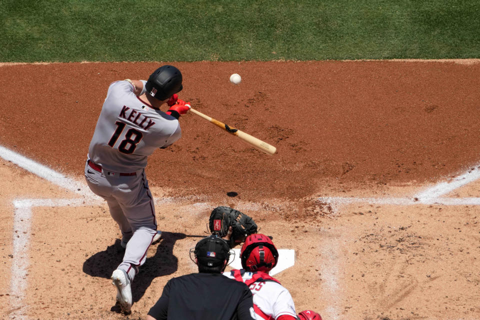 Jul 2, 2023; Anaheim, California, USA; Arizona Diamondbacks catcher Carson Kelly (18) hits a two-run home run in the second inning against the Los Angeles Angels at Angel Stadium. Mandatory Credit: Kirby Lee-USA TODAY Sports